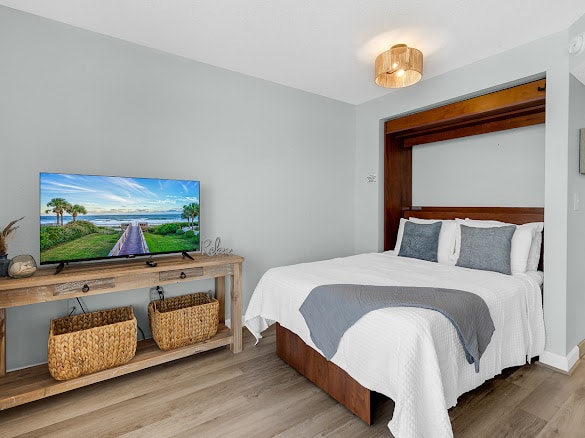 Murphy bed deployed — dining table converts to a comfortable queen bed